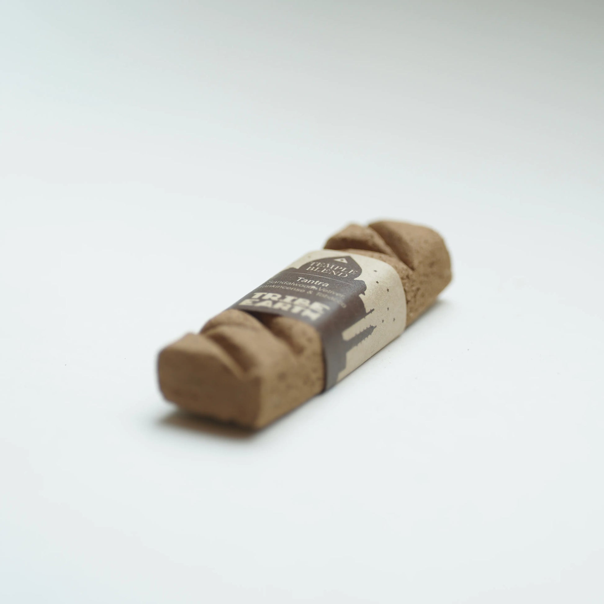 A Tribe earth tantra incense photographed on a clean white background.