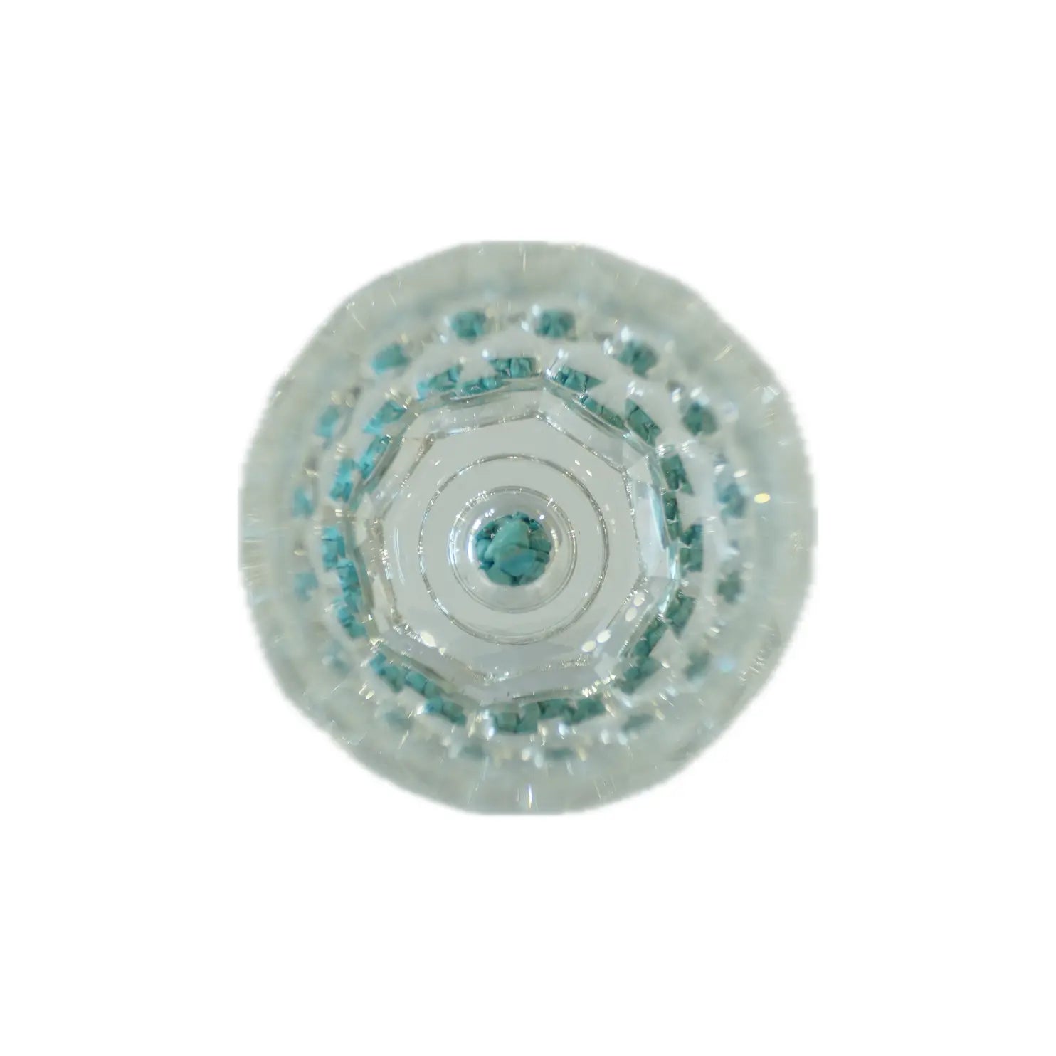 Close-up of a round, decorative glass piece featuring intricate layers of light blue gemstones arranged in a geometric pattern.