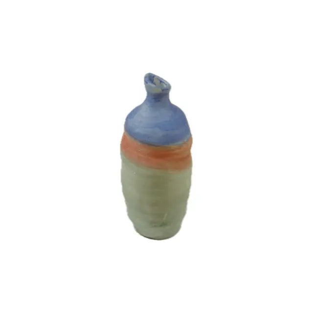 A small, handcrafted ceramic vase with a blue top, orange middle, and green base, showcasing a smooth, rounded design on a white background.