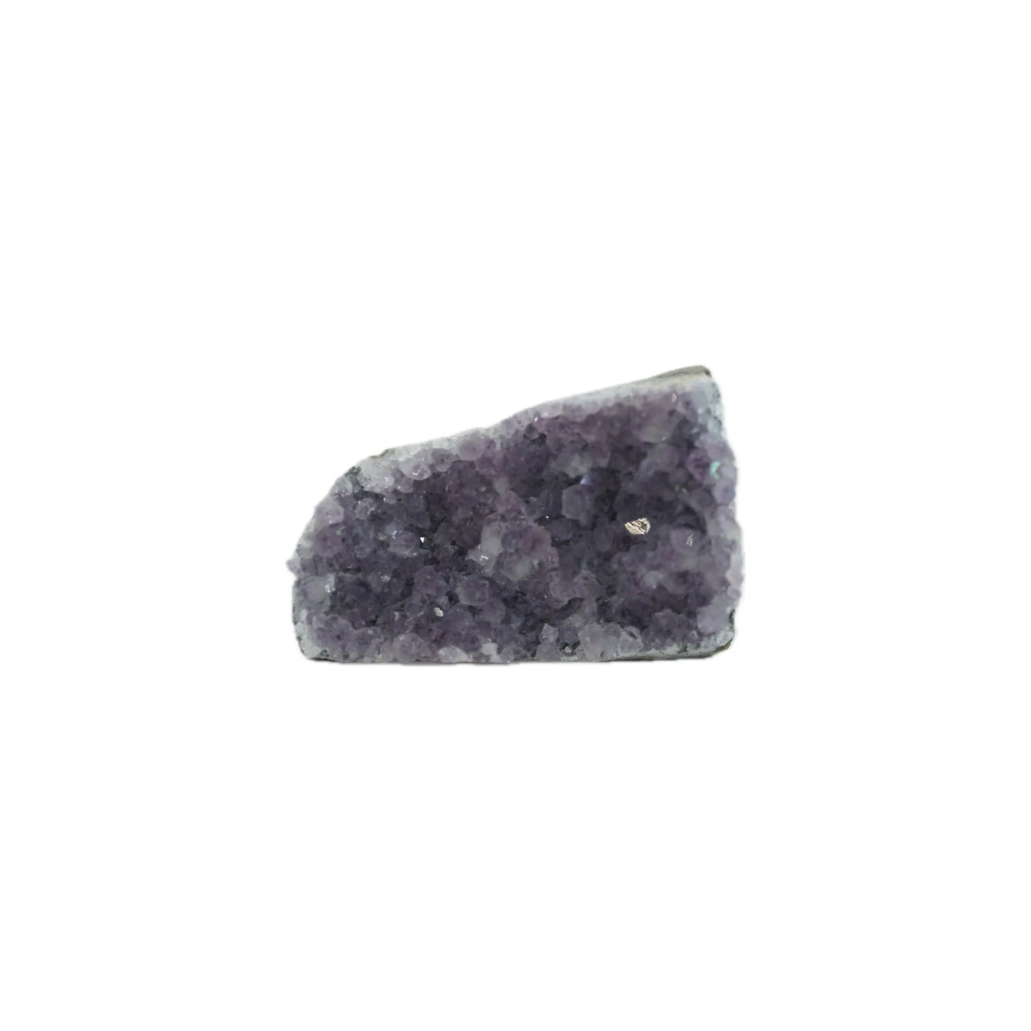 Purple amethyst crystal cluster with a rough, jagged surface isolated on a white background.