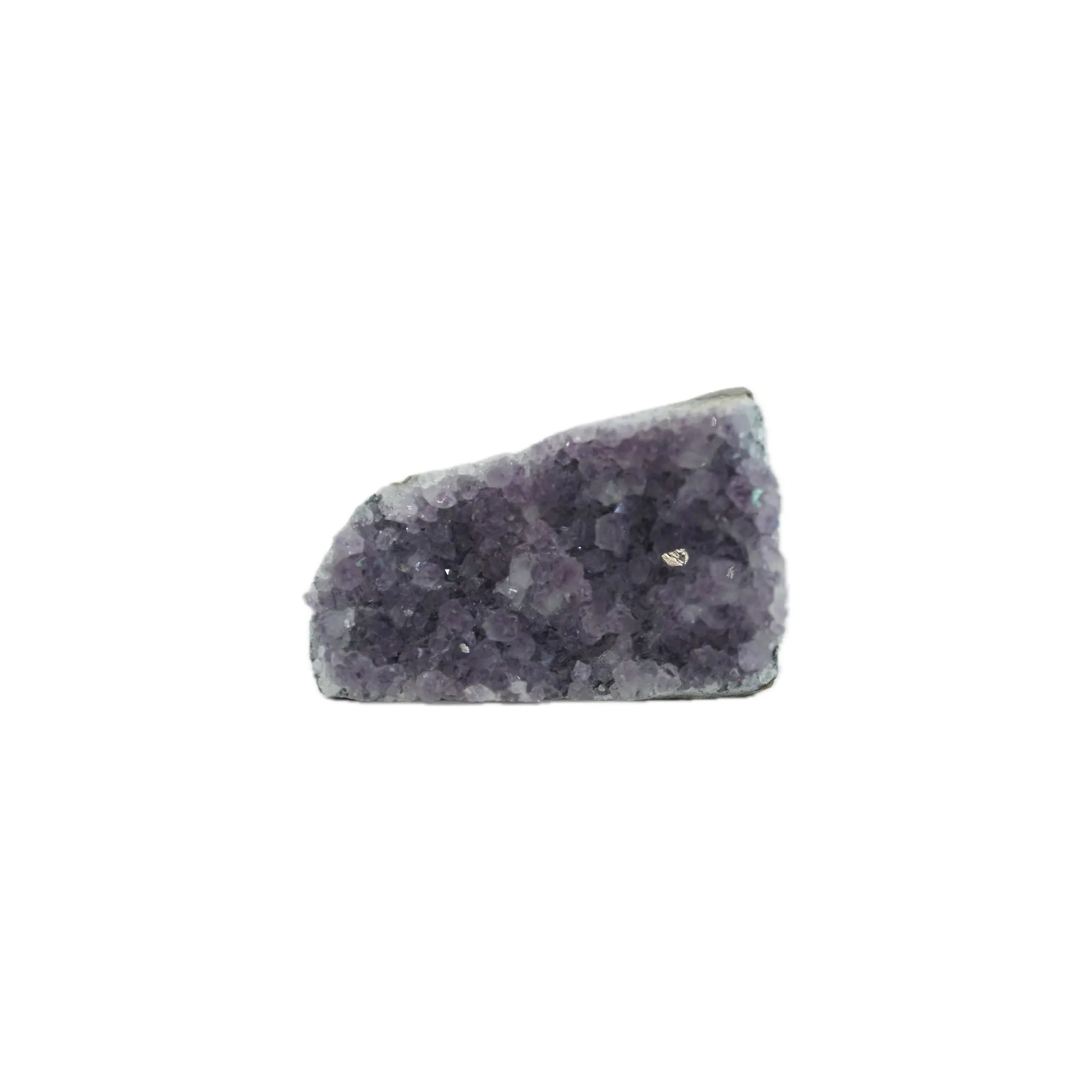 Purple amethyst crystal cluster with a rough, jagged surface isolated on a white background.