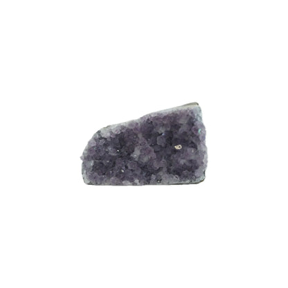 Purple amethyst crystal cluster with a rough, jagged surface isolated on a white background.