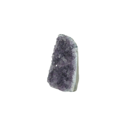 A raw amethyst crystal cluster with dark purple crystalline points and a light gray to off-white base, isolated on a solid white background.