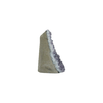 A triangular wedge-shaped decorative object featuring a textured gray-green stone-like face and a rough, glittering lavender-purple crystal or amethyst geode interior, isolated on a solid white background.