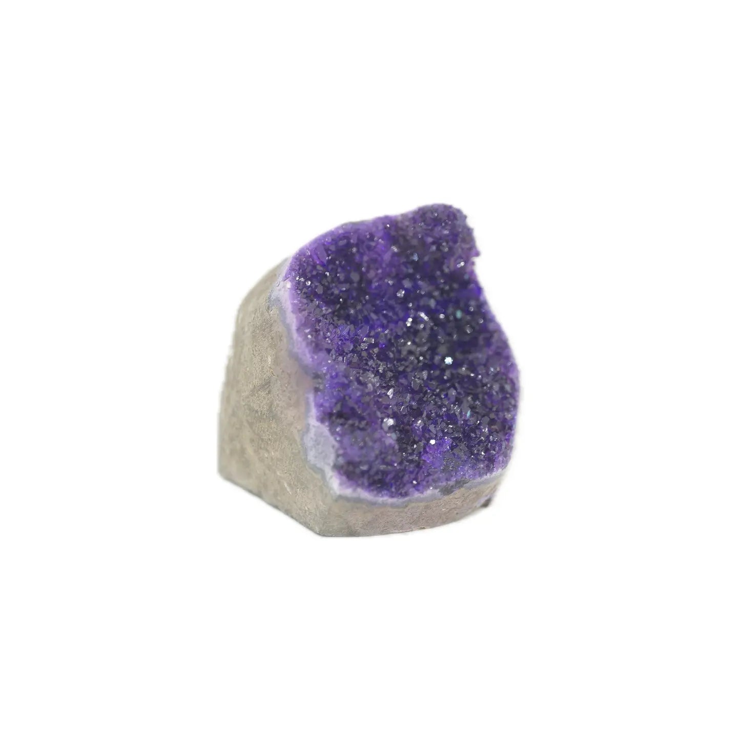 A raw amethyst geode specimen with a deep purple crystal cavity and a rough, light gray matrix base, shown on a plain white background.
