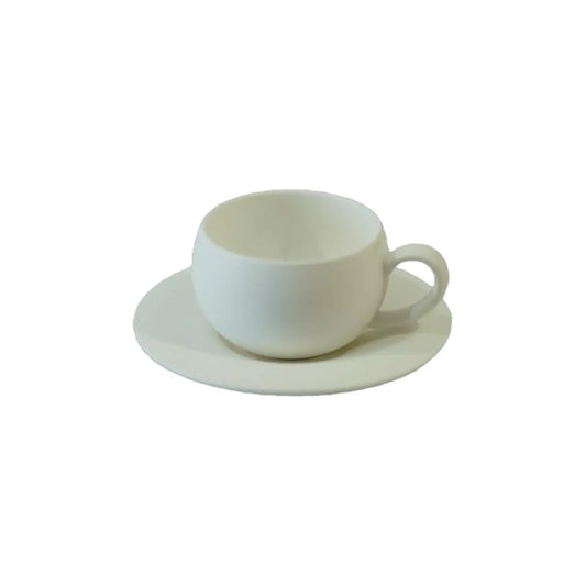 A simple, white ceramic cup with a handle, resting on a matching circular saucer, against a plain background.