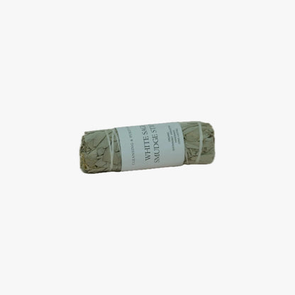 A bundled white sage smudge stick with a white paper label reading 'WHITE SAGE SMUDGE STICK' on a plain white background.