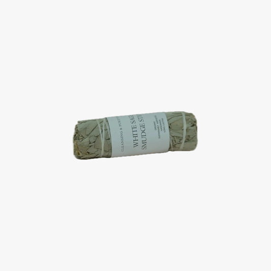 A bundled white sage smudge stick with a white paper label reading 'WHITE SAGE SMUDGE STICK' on a plain white background.