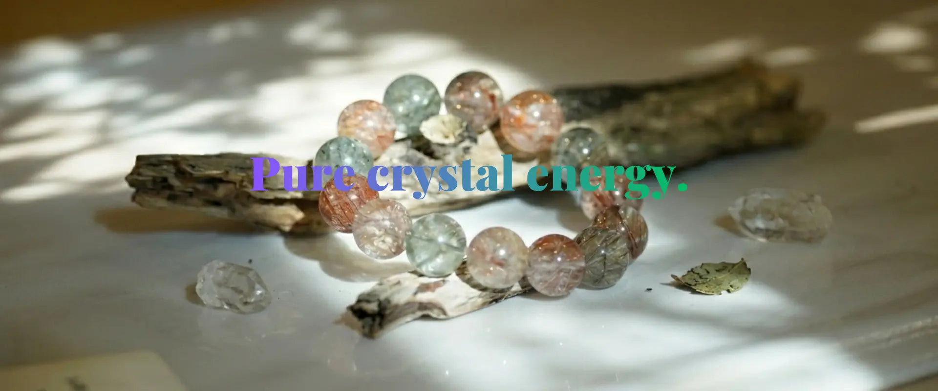 "Handcrafted natural gemstone crystal bracelet featuring rutilated quartz beads on driftwood, positioned as a mindfulness banner for positive energy at Singoau."