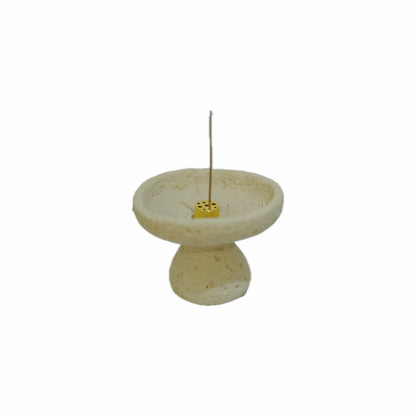 Hand-textured cement incense burner with a lit incense stick, showcasing the functional art and time vortex design.